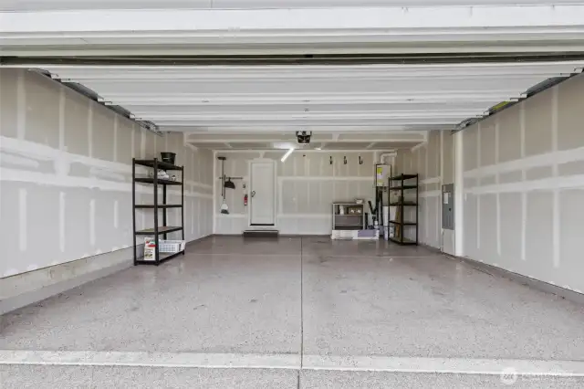 2 car garage w/ epoxy floors, and a tankless water heater on right.