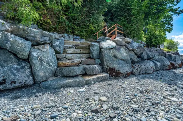 The property is protected by a tall rock bulkhead.