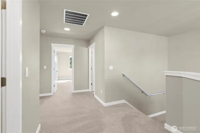 Spacious upper landing with soft carpet and recessed lighting.