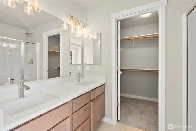 Primary bath is stunning with a double vanity, undermount sinks and backsplash.
