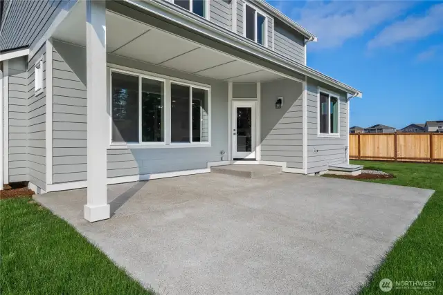 Covered back porch with extended patio for additional outdoor space.
