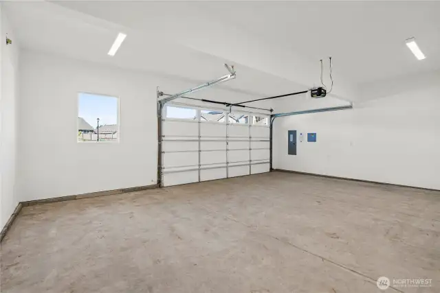 Double car garage is drywalled and includes standard garage door opener.