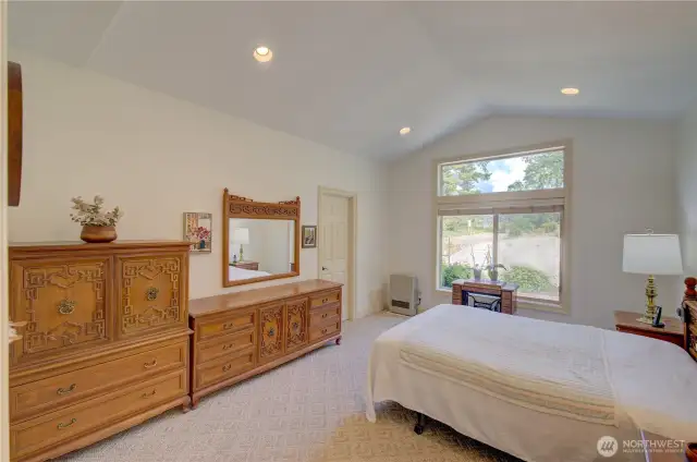 Primary Suite with walk in closet and full bath including jetted tub and shower. The doorway goes to the bath