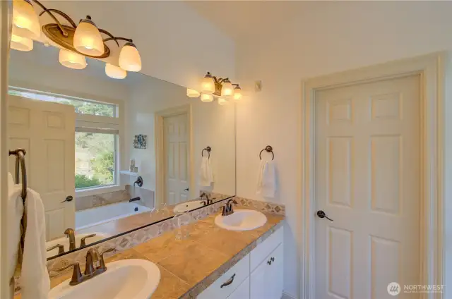 Primary suite full bath including jetted tub and shower. The doorway goes to the water closet and walk in shower.