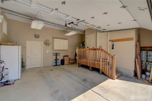 Two car garage with extra storage or shop space through the door.
