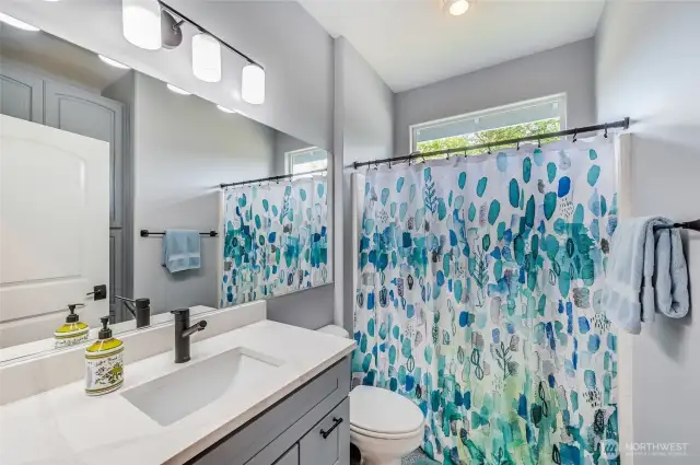 The main bath is adjacent to the second bedroom and has been updated with a new vanity, undermount sink, new faucet and quartz counter.
