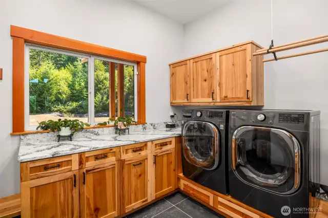 Laundry room complete with sink, hickory cabinets and plenty of counterspace