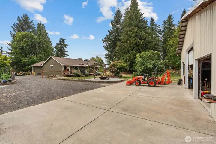 View of the Backyard w/Paved Parking in front of the Shop