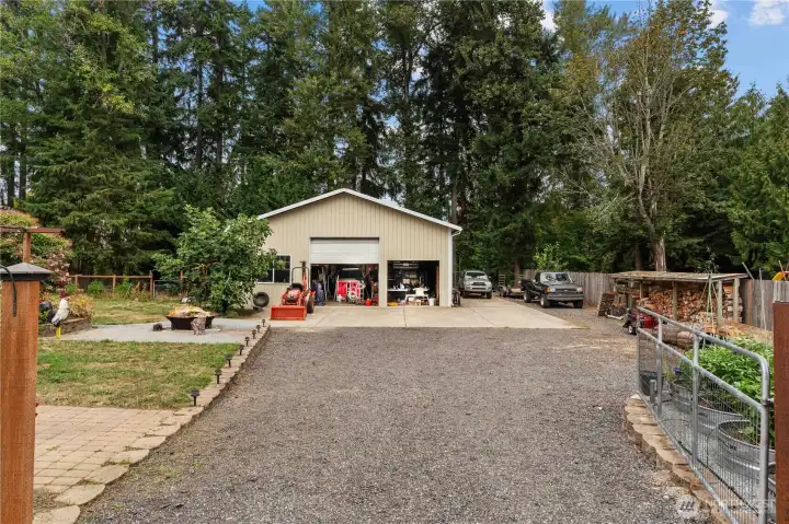 Massive 1440 sqft (36x40) Shop w/Loft and 12x12 Door fits a Class A/36' RV. Second 8 Foot Door. Lift inside is negotiable. Carport on the Left and RV Parking & Hookups on the Right.