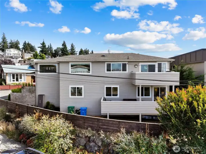 Side view showing decks off the upstairs nook & primary bedroom