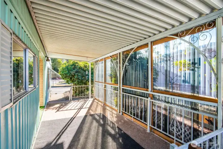 Spacious covered porch offers the perfect spot to enjoy your morning coffee or unwind with friends outdoors.