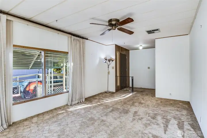 Comfortable living area with ceiling fan and cozy layout, perfect for relaxing or visiting with friends.