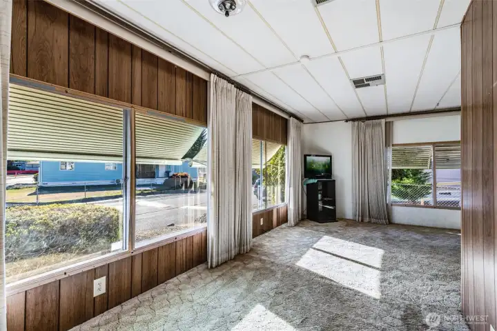 Alternate view of the dining area highlights its generous window seating and bright, welcoming atmosphere.