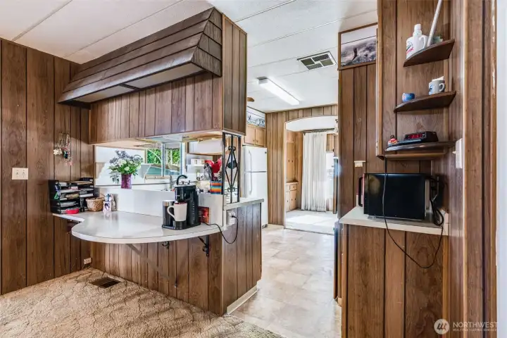 Kitchen peninsula adds extra counter space and an easy spot for casual meals or morning coffee.