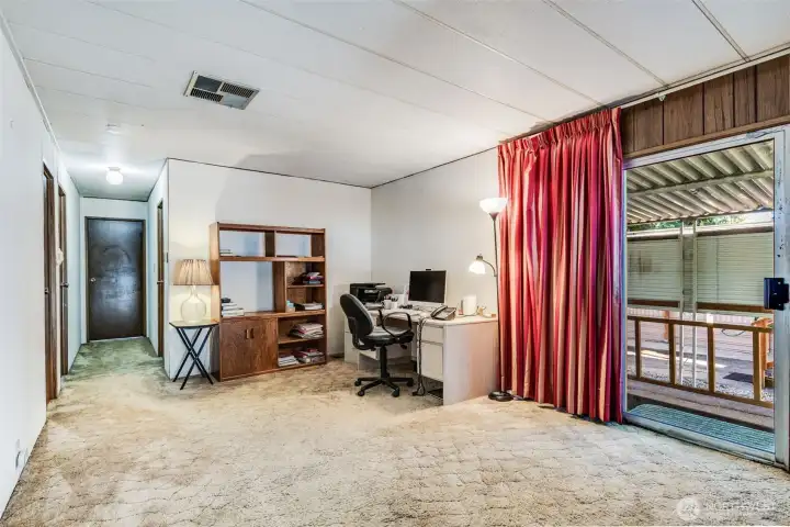 Open view of the den shows its flexible layout—ideal for hobbies, a home office, or cozy TV nook.