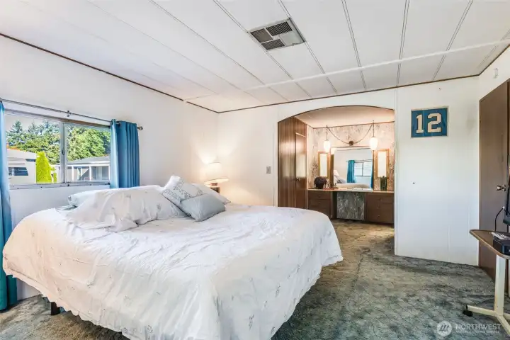 Primary bedroom features private ensuite access and generous space for added comfort and convenience.