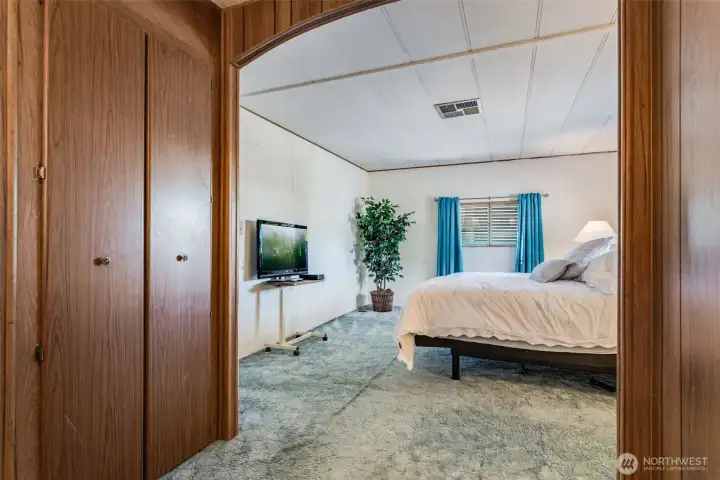 Primary suite offers ample space for a full bedroom set and easy access to the private bath.