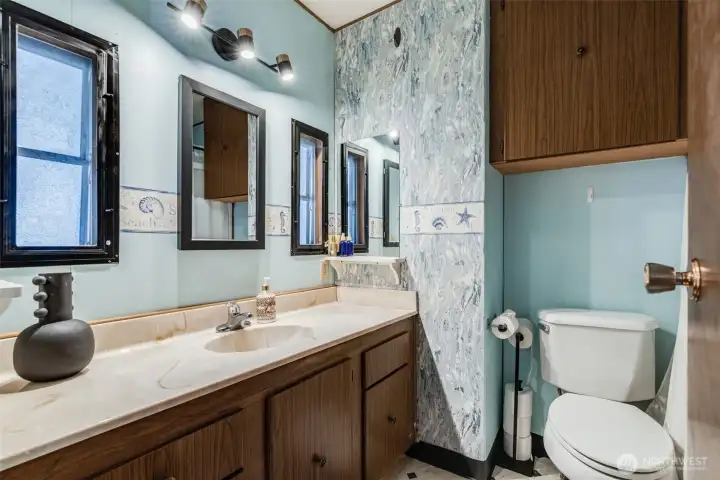 Full guest bathroom with a convenient tub/shower combo and large vanity with storage.