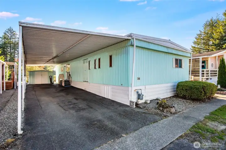 Extended carport offers covered parking and easy access to the home in any weather.