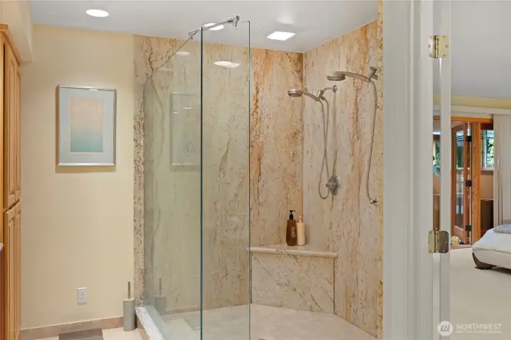 Double headed glass enclosed shower.