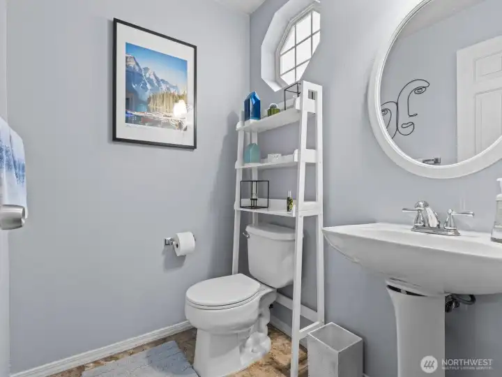 Immediately to the right is the conveniently located powder room.