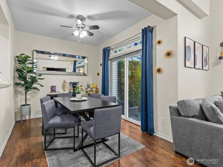 On the other side of the kitchen is the dining room with sliding glass door to the patio space.