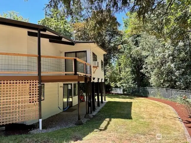 Rear view of home, woods behind