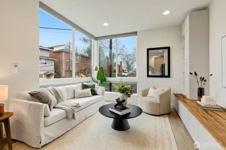 Love this living room - bright, airy, and chic with custom storage/seating built in. Custom blinds give you privacy and light filtering options.