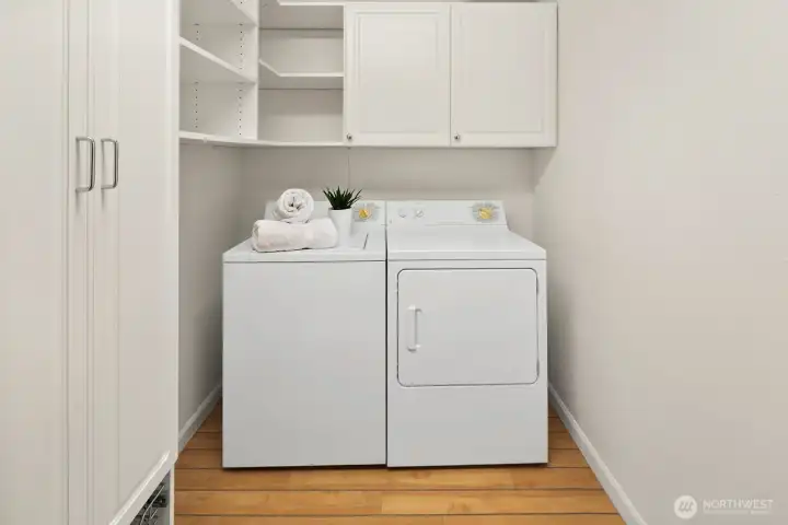 In-unit laundry and storage room with custom closet system by Closet by Design