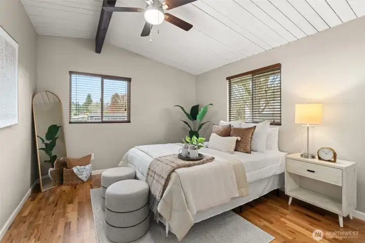 Tucked into the rear corner is this peaceful primary sanctuary. Windows on 2 walls bring tons of light, added insulation to R-30 under the floor ensures that this room stays cozy. Just look at those beautiful refinished original hardwoods!