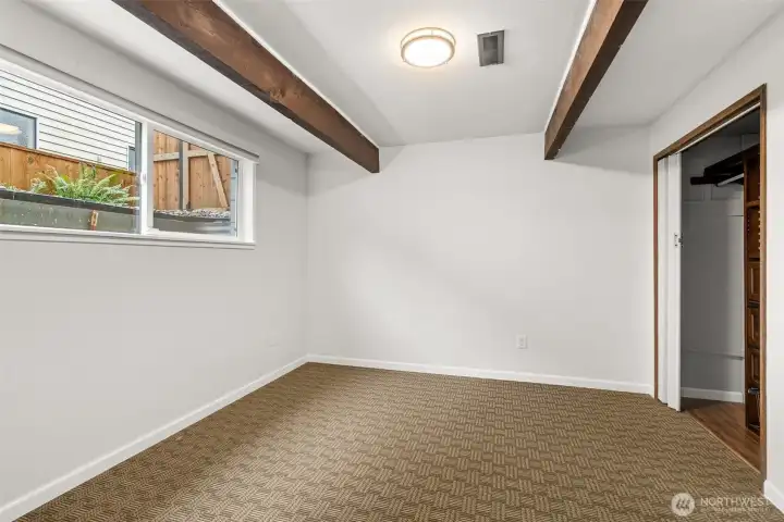 One of 2 lower level bedrooms - beside the closet just beyond the right edge of the photo is a built-in desk area.