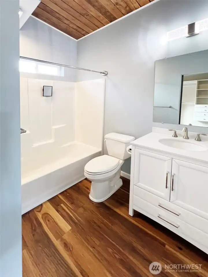 Full bath in ADU - vaulted ceilings and window for light & added ventilation.