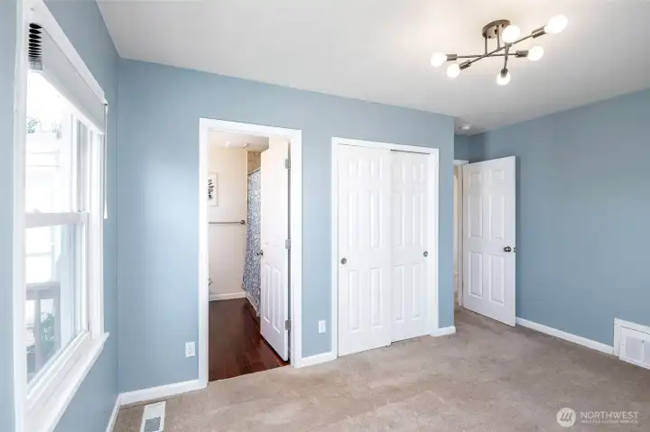 Primary Bedroom with great windows for SW afternoon/evening sunlight on Main Floor [Full Bath = Shower, Tub, Toilet, Double Vanity]. Insulated Windows. HVAC provides year round comfort.