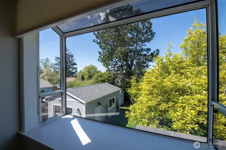 This atrium window is at the top of the spacious landing at the top of the stairs. This window lets in the SW evening sun for great daylight. This custom window also has Hunter Douglas "motorized-remote-controlled blind".