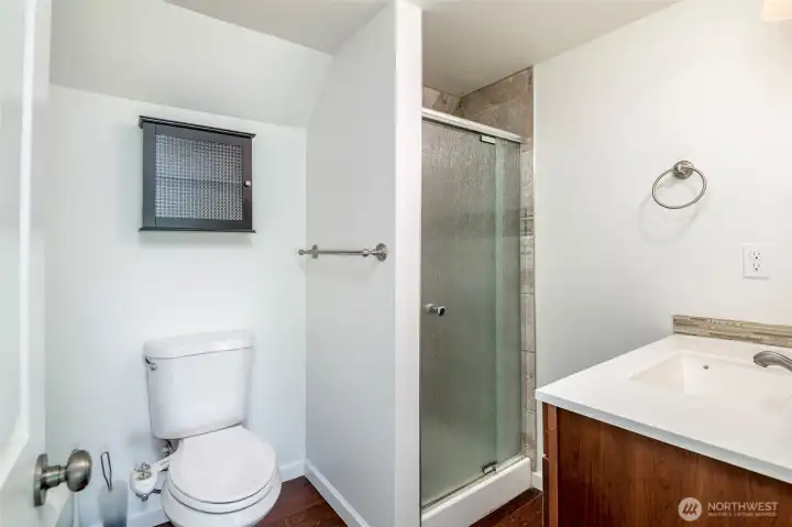 Common bath/shower just a step away from the 2 upper bedrooms.   Mature landscaping surrounds the home with established trees, shrubs, and seasonal blooms. Relax on the back patio under a green canopy all summer next to the outdoor stone fire pit. A dry, semi-finished basement offers flexible rec room / home gym space with fresh flooring.    Fully fenced property with 6' privacy fencing in back and black chain-link fencing with a remote-controlled rolling gate at the front. Deep driveway offers multiple off-street parking spots and leads to newer 14’x24’ detached garage with an extra tall ceiling offering generous storage options and accommodation for tall vehicles.    Roof and side sewer u