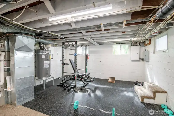 Semi Finished Basement.  Currently used as an exercise area. Furnace & H20 tank located here as well.   Mature landscaping surrounds the home with established trees, shrubs, and seasonal blooms. Relax on the back patio under a green canopy all summer next to the outdoor stone fire pit. A dry, semi-finished basement offers flexible rec room / home gym space with fresh flooring.    Fully fenced property with 6' privacy fencing in back and black chain-link fencing with a remote-controlled rolling gate at the front. Deep driveway offers multiple off-street parking spots and leads to newer 14’x24’ detached garage with an extra tall ceiling offering generous storage options and accommodation for tall vehicles.    Roof and side sewer u