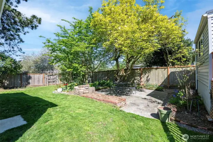 Perfect size lawn with patio & garden spaces make this outdoor oasis easy to maintain & relax in.