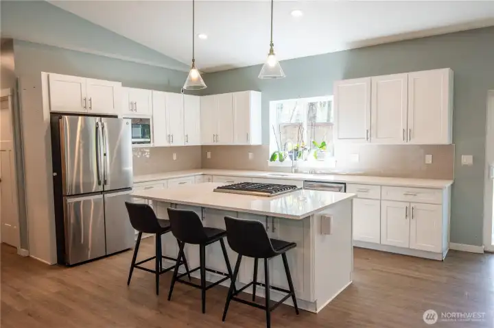 Light bright kitchen with quartz countertops and huge island!
