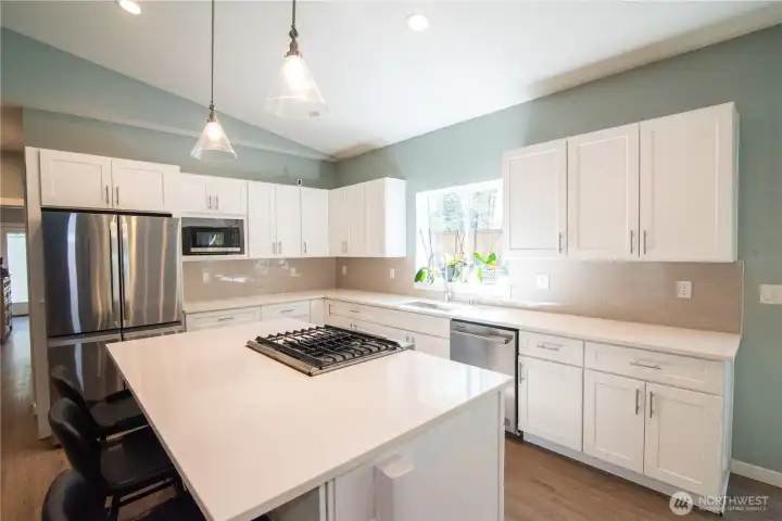 Chef's kitchen with gas stove and oven located in the island!