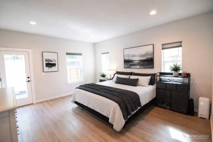 Spacious main floor primary bedroom with private entry and more incredible natural light!
