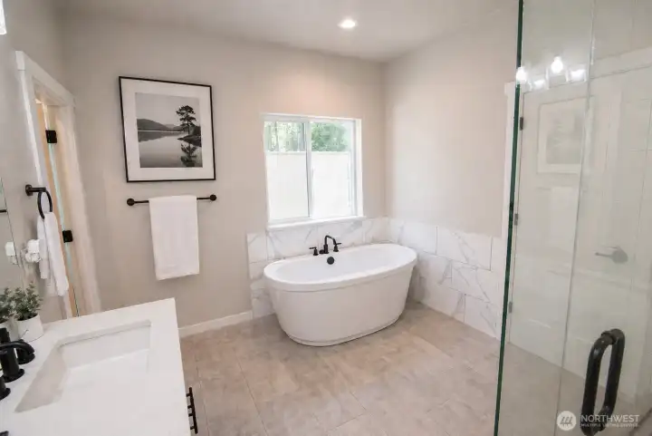 Luxurious soaking tub makes this primary ensuite feel like a spa!