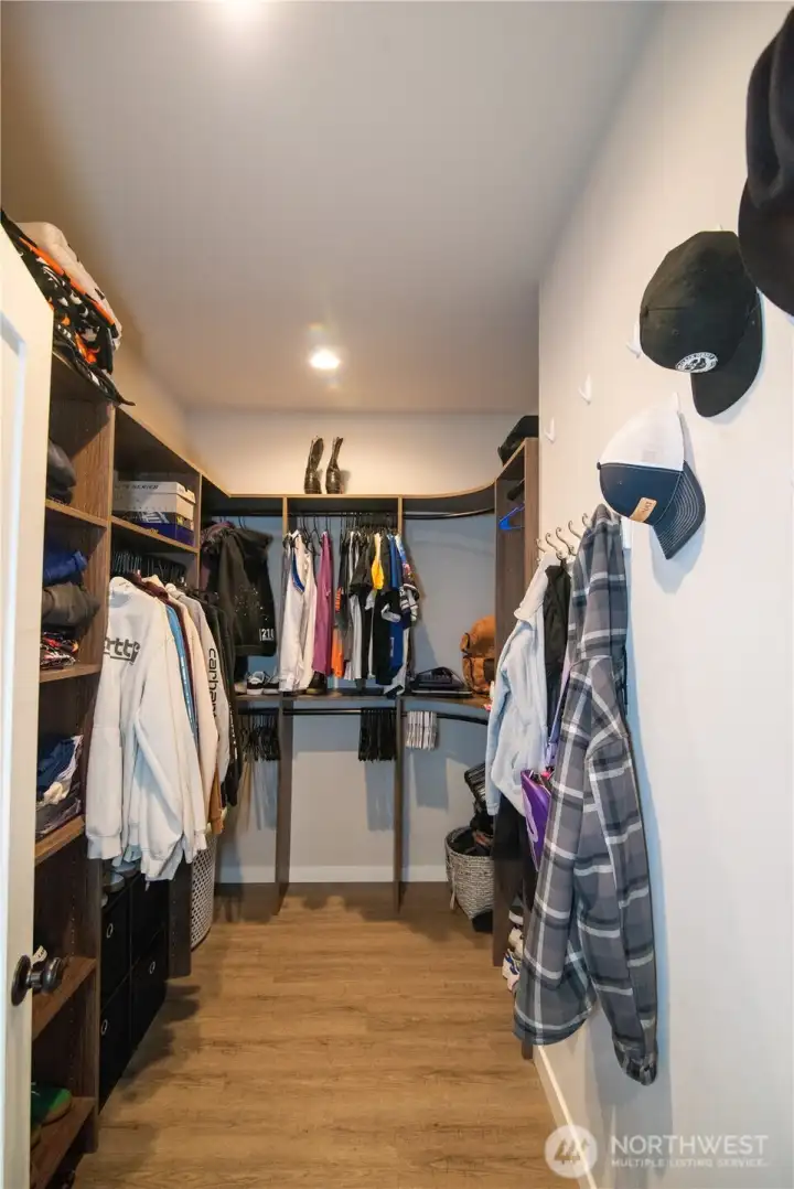 Built in cabinetry in this primary closet for organized storage in style!