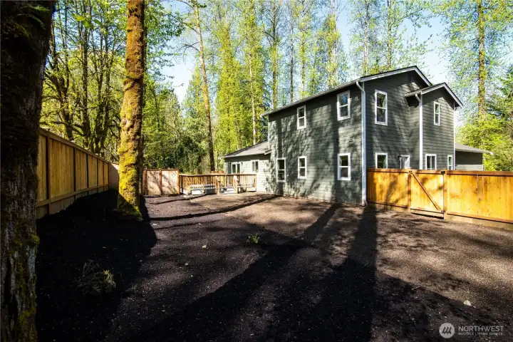 Back yard with fresh mulch, soil and natural landscaping, ready to make your dream yard come true!