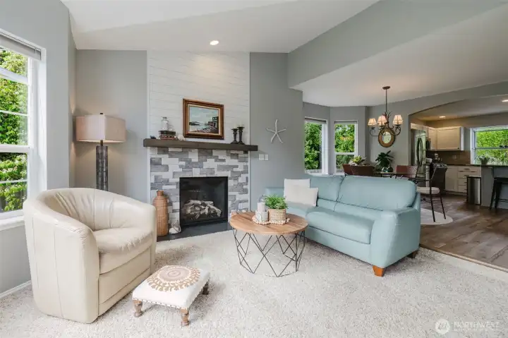 Inviting living room with gas fireplace, stone and shiplap