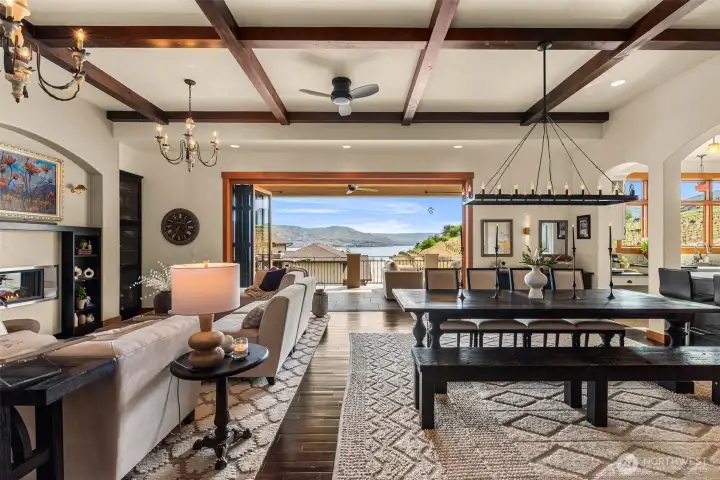 Sophisticated great room with dramatic beams, fireplace, and a huge Nana wall inviting you to the covered deck and Lake Chelan views