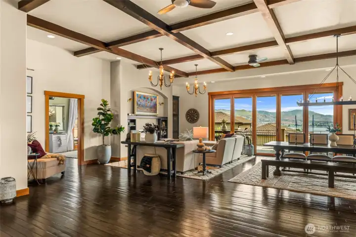 Spacious living and dining areas framed by beautiful mountain and lake views. The door on the left leads to the primary suite.