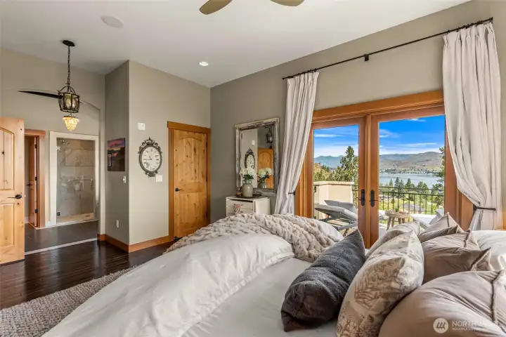 Spacious primary retreat with private balcony access and stunning lake views