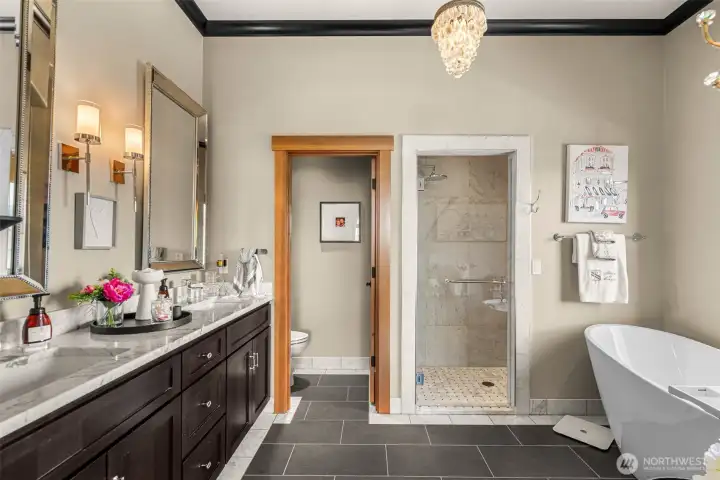 Sophisticated spa bath featuring dual sinks, a luxurious walk-in shower and soaking tub with a view