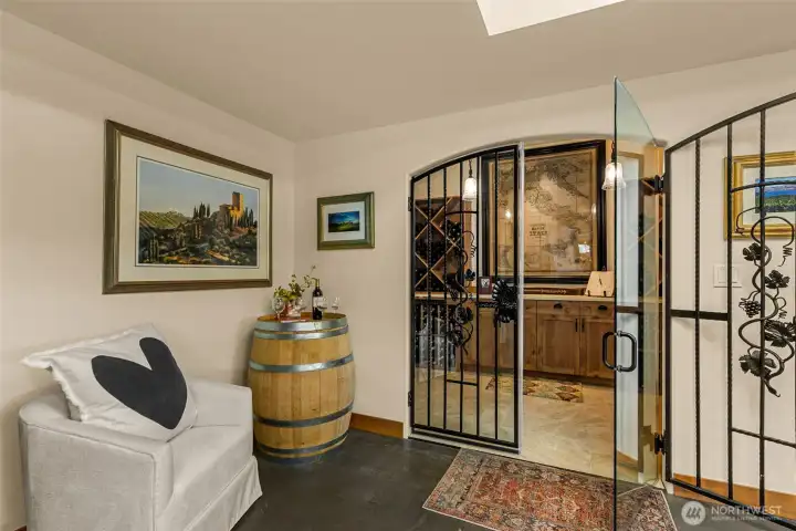 Temperature controlled wine cellar with wrought iron doors and Tuscan-inspired ambiance
