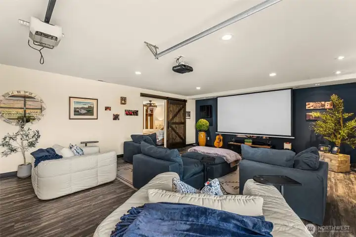 Big family room with projector and screen creates the ultimate movie and game-day experience